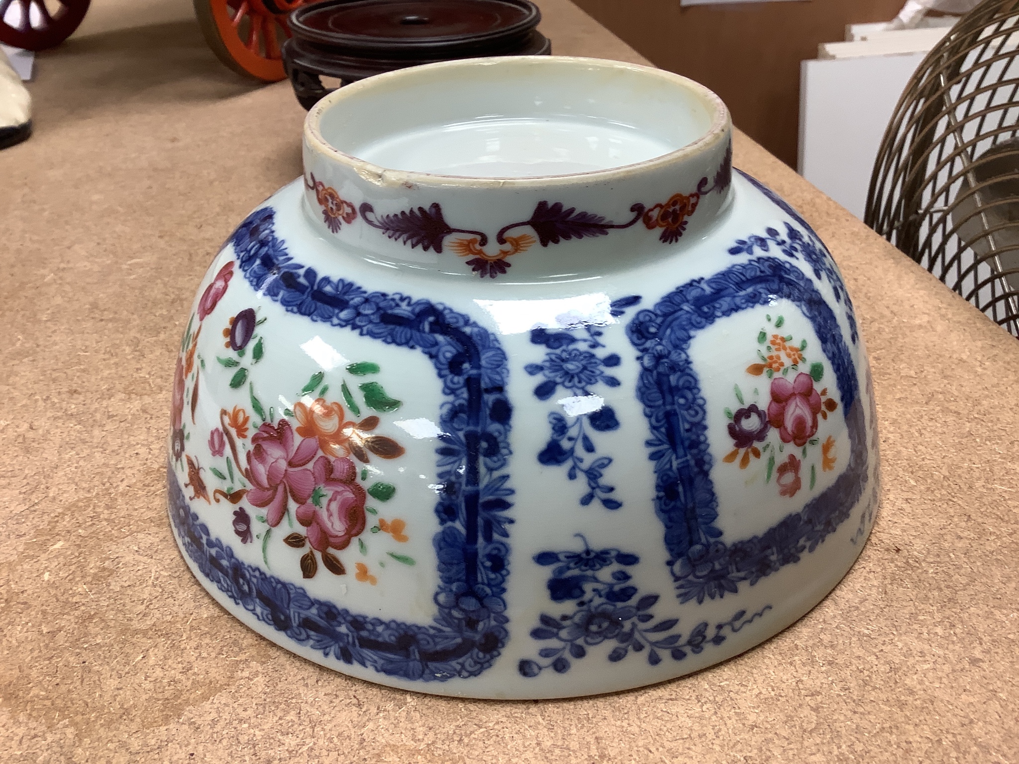 A 18th century Chinese export porcelain footed punch bowl on hardwood stand, diameter 20cm, restored